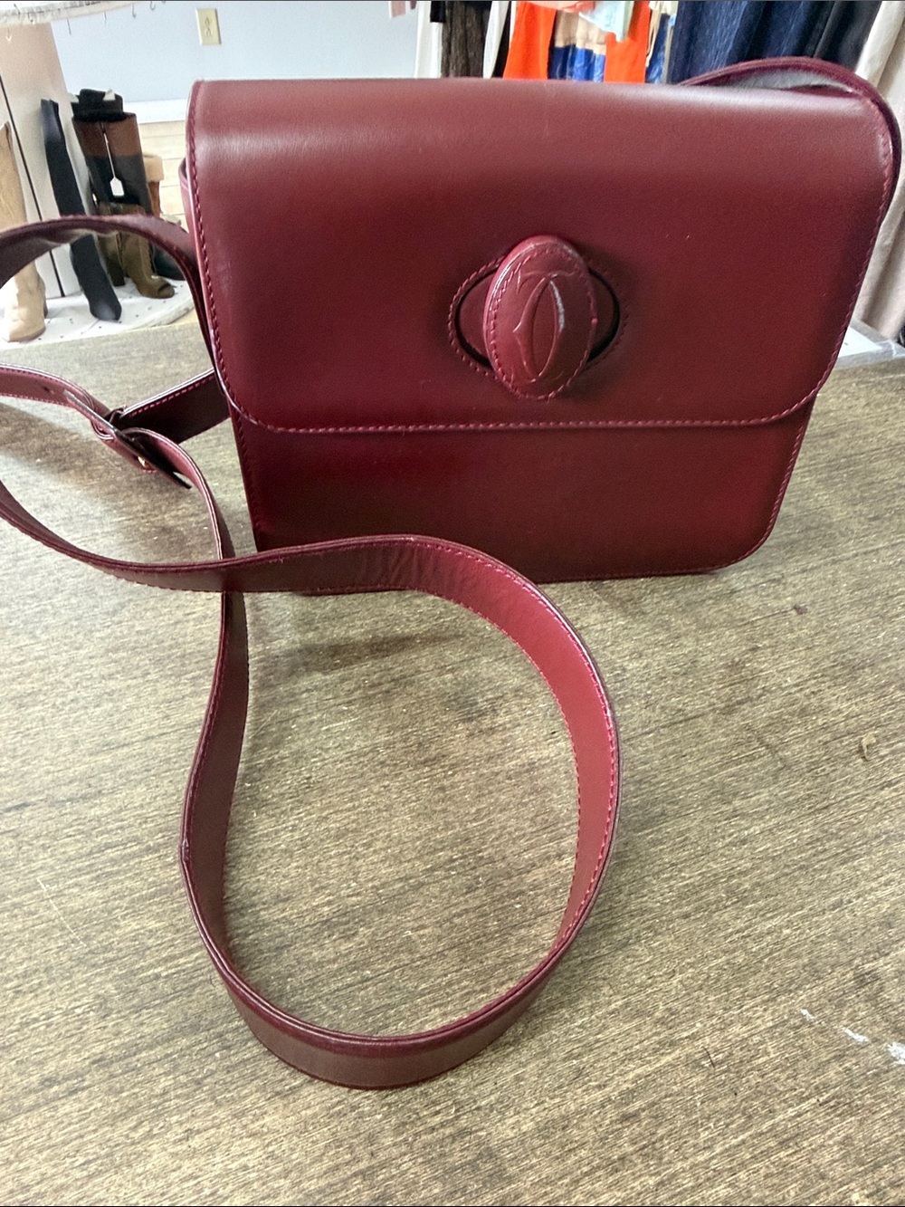 Cartier Burgundy Leather Shoulder Bag with Gold Accent.